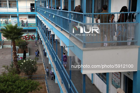 Women bring their children to the United-Nation run Elementary School on the first day of the new school year as Palestinians ease the coron...