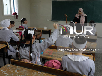 A teacher interacts with students in a classroom at a United Nations-run school as a new school year begins as Palestinians ease the coronav...