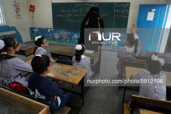 A teacher interacts with students in a classroom at a United Nations-run school as a new school year begins as Palestinians ease the coronav...