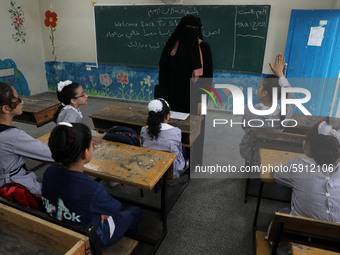 A teacher interacts with students in a classroom at a United Nations-run school as a new school year begins as Palestinians ease the coronav...