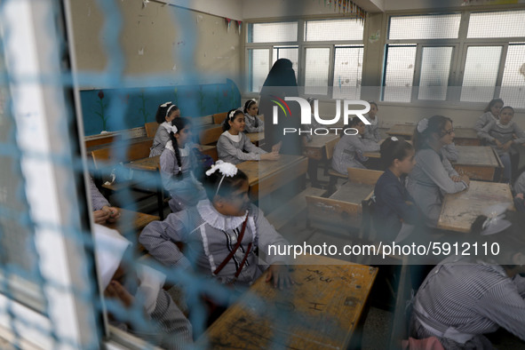 Palestinian students sit in a classroom at a United-Nations run school as a new school year begins as Palestinians ease the coronavirus dise...