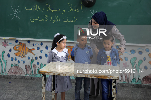 A teacher interacts with students in a classroom at a United Nations-run school as a new school year begins as Palestinians ease the coronav...