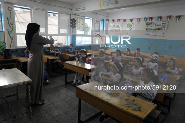 A teacher interacts with students in a classroom at a United Nations-run school as a new school year begins as Palestinians ease the coronav...