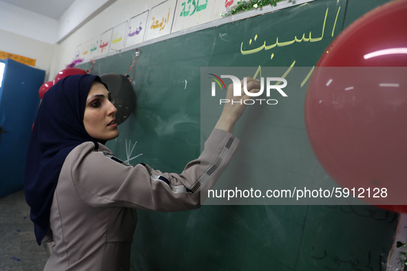 A teacher interacts with students in a classroom at a United Nations-run school as a new school year begins as Palestinians ease the coronav...