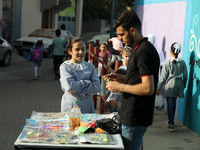 Palestinian students buy from a street vendor outside a United-Nations run school as a new school year begins as Palestinians ease the coron...