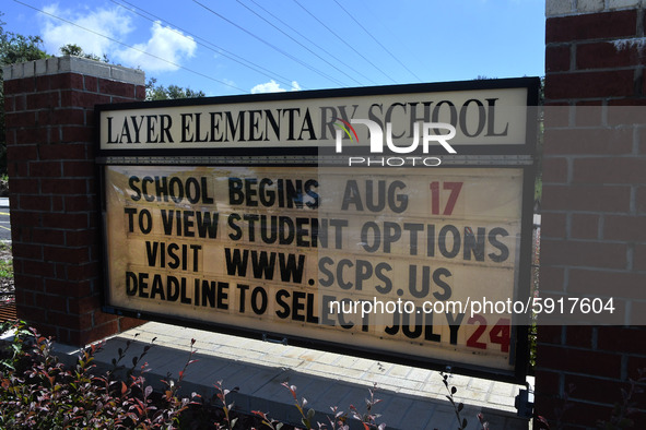 A sign at the entrance to Layer Elementary School advises that the school year will begin on August 17 with several student learning options...