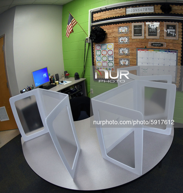 Desk shields are seen on a circular desk in a classroom at Layer Elementary School during a media preview a week before classes begin for th...