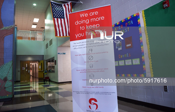 Heath safety precautions are seen posted in the lobby at Layer Elementary School a week before classes begin for the school year during the...