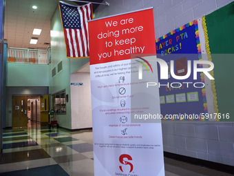 Heath safety precautions are seen posted in the lobby at Layer Elementary School a week before classes begin for the school year during the...