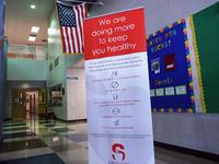 Heath safety precautions are seen posted in the lobby at Layer Elementary School a week before classes begin for the school year during the...