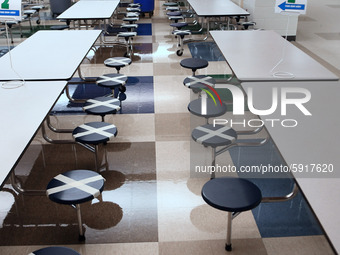 The cafeteria with seats designated to provide social distancing is seen at Layer Elementary School during a media preview a week before cla...