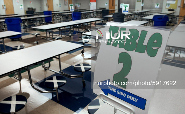 The cafeteria with seats designated to provide social distancing is seen at Layer Elementary School during a media preview a week before cla...