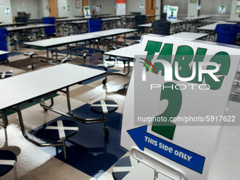 The cafeteria with seats designated to provide social distancing is seen at Layer Elementary School during a media preview a week before cla...