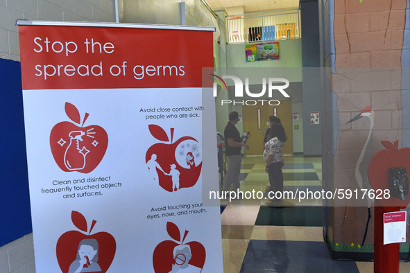 Heath safety precautions are seen posted in the lobby at Layer Elementary School a week before classes begin for the school year during the...