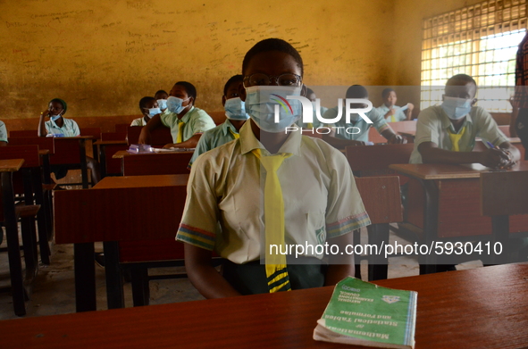 The final year students of Babs Fafunwa Millennium Senior Grammar School, Ojodu, Lagos, Nigeria sit with facemasks in a classroom as they wa...