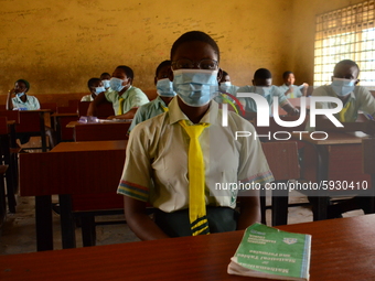 The final year students of Babs Fafunwa Millennium Senior Grammar School, Ojodu, Lagos, Nigeria sit with facemasks in a classroom as they wa...