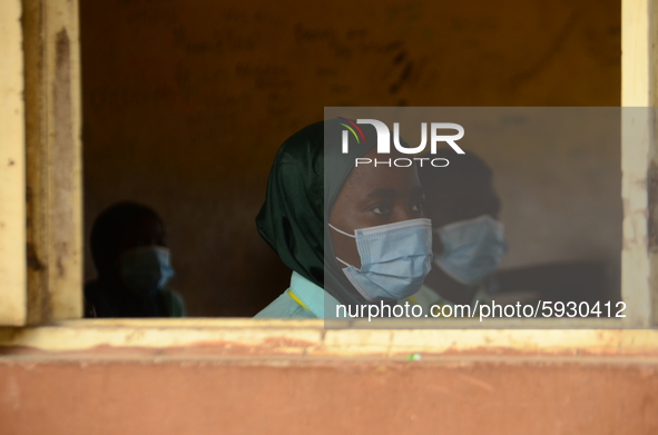 The final year students of Babs Fafunwa Millennium Senior Grammar School, Ojodu, Lagos, Nigeria sit with facemasks in a classroom as they wa...