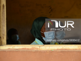 The final year students of Babs Fafunwa Millennium Senior Grammar School, Ojodu, Lagos, Nigeria sit with facemasks in a classroom as they wa...