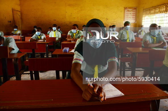 The final year students of Babs Fafunwa Millennium Senior Grammar School, Ojodu, Lagos, Nigeria sit with facemasks in a classroom as they wa...