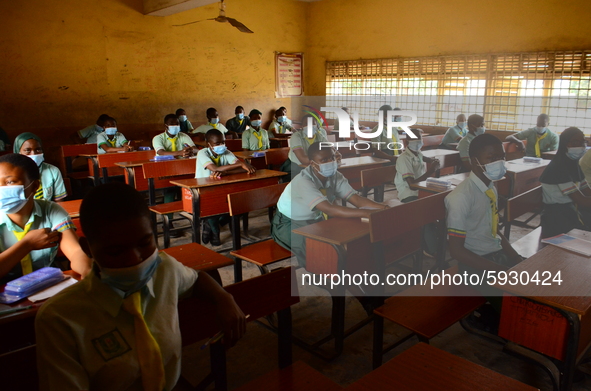 The final year students of Babs Fafunwa Millennium Senior Grammar School, Ojodu, Lagos, Nigeria sit with facemasks in a classroom as they wa...