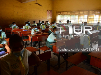 The final year students of Babs Fafunwa Millennium Senior Grammar School, Ojodu, Lagos, Nigeria sit with facemasks in a classroom as they wa...