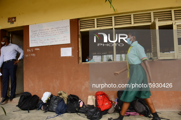 A final year students of Babs Fafunwa Millennium Senior Grammar School, Ojodu, Lagos, Nigeria, wearing a facemask leaves a classroom before...