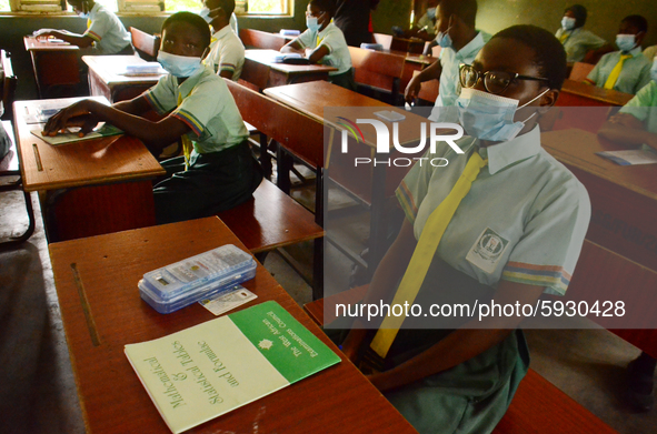 The final year students of Babs Fafunwa Millennium Senior Grammar School, Ojodu, Lagos, Nigeria sit with facemasks in a classroom as they wa...