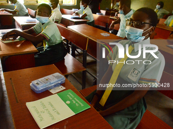 The final year students of Babs Fafunwa Millennium Senior Grammar School, Ojodu, Lagos, Nigeria sit with facemasks in a classroom as they wa...