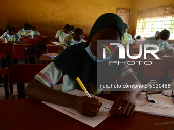 The final year students of Babs Fafunwa Millennium Senior Grammar School, Ojodu, Lagos, Nigeria sit with facemasks in a classroom as they co...