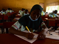 The final year students of Babs Fafunwa Millennium Senior Grammar School, Ojodu, Lagos, Nigeria sit with facemasks in a classroom as they co...