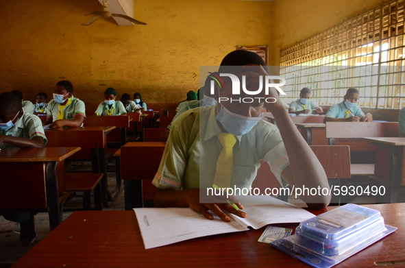 The final year students of Babs Fafunwa Millennium Senior Grammar School, Ojodu, Lagos, Nigeria sit with facemasks in a classroom as they co...