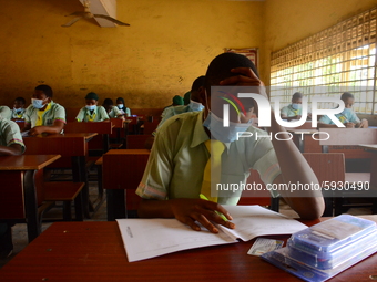 The final year students of Babs Fafunwa Millennium Senior Grammar School, Ojodu, Lagos, Nigeria sit with facemasks in a classroom as they co...