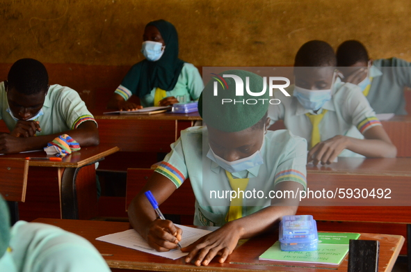 The final year students of Babs Fafunwa Millennium Senior Grammar School, Ojodu, Lagos, Nigeria sit with facemasks in a classroom as they co...