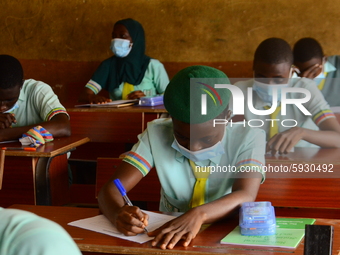 The final year students of Babs Fafunwa Millennium Senior Grammar School, Ojodu, Lagos, Nigeria sit with facemasks in a classroom as they co...