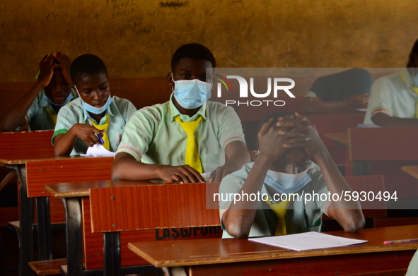 The final year students of Babs Fafunwa Millennium Senior Grammar School, Ojodu, Lagos, Nigeria sit with facemasks in a classroom as they co...