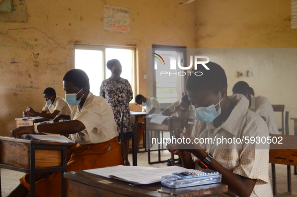 Final year students of Agidinbi Senior Grammar School,Ikeja, Lagos, wearing a facemask write on her hand during The West African Senior Seco...