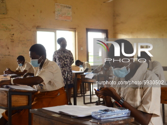 Final year students of Agidinbi Senior Grammar School,Ikeja, Lagos, wearing a facemask write on her hand during The West African Senior Seco...