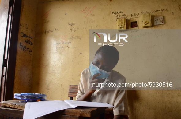 A final year students of Agidinbi Senior Grammar School,Ikeja, Lagos, wearing a facemask write on examination answer sheet during The West A...