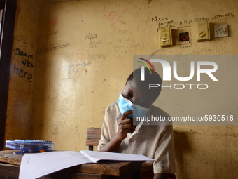 A final year students of Agidinbi Senior Grammar School,Ikeja, Lagos, wearing a facemask write on examination answer sheet during The West A...