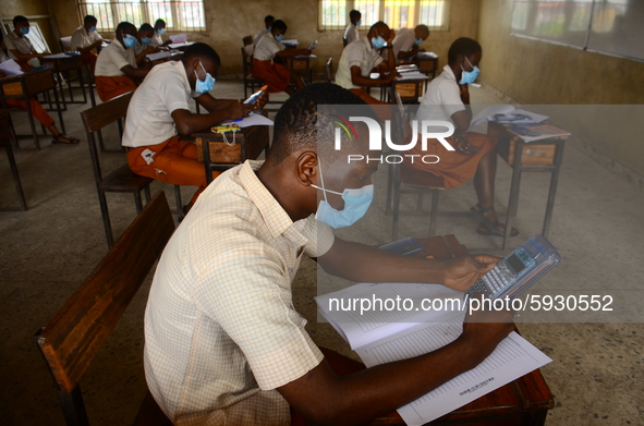 Final year students of Agidinbi Senior Grammar School,Ikeja, Lagos, wearing a facemask write on examination answer sheets during The West Af...