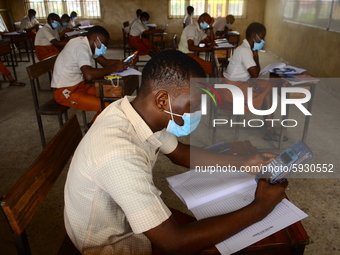 Final year students of Agidinbi Senior Grammar School,Ikeja, Lagos, wearing a facemask write on examination answer sheets during The West Af...