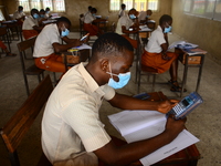 Final year students of Agidinbi Senior Grammar School,Ikeja, Lagos, wearing a facemask write on examination answer sheets during The West Af...