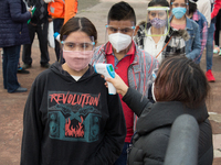 Before entering the University Olympic Stadium, undergraduate applicants had their body temperature measured and received antibacterial gel....