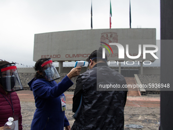 Before entering the University Olympic Stadium, undergraduate applicants had their body temperature measured and received antibacterial gel....