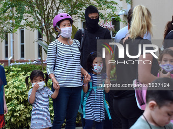 Children wait to enter the school building on the first day of in-person classes in Orange County at Baldwin Park Elementary School on Augus...