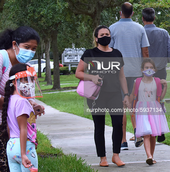 Parents accompany their children to school on the first day of in-person classes in Orange County at Baldwin Park Elementary School on Augus...