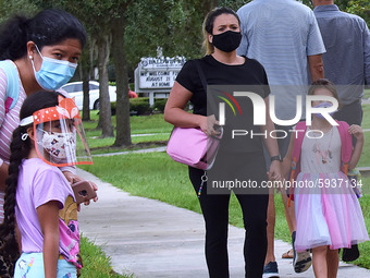 Parents accompany their children to school on the first day of in-person classes in Orange County at Baldwin Park Elementary School on Augus...