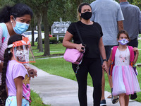 Parents accompany their children to school on the first day of in-person classes in Orange County at Baldwin Park Elementary School on Augus...