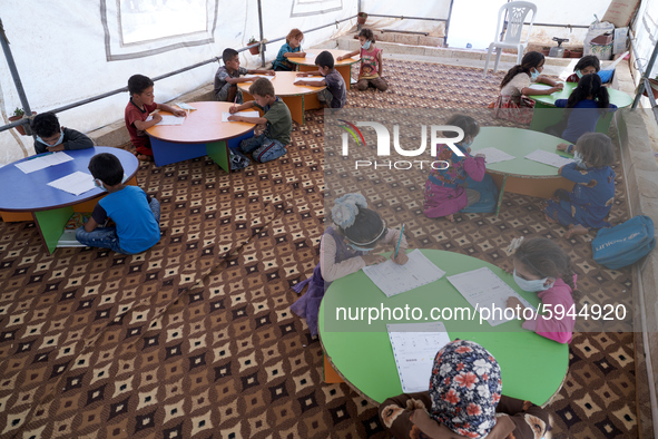 Syrian students take a math lesson in a refugee camp near Syrian-Turkish borders in Idlib, Syria, on August 25, 2020. 