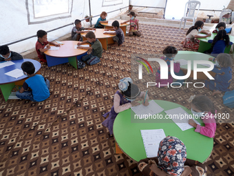 Syrian students take a math lesson in a refugee camp near Syrian-Turkish borders in Idlib, Syria, on August 25, 2020. (